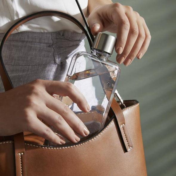 Slim memobottle sliding into handbag